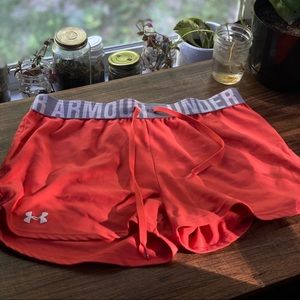 Orange under Armour running/workout shorts.